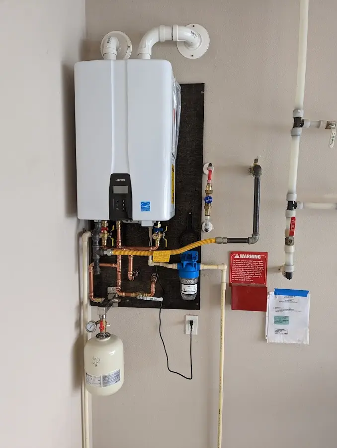 Professional plumber installing copper piping in a Andalusia home